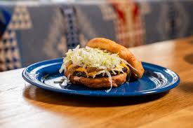 Javelina signature dishes Frybread Tacos (NDN Taco), Powwow Burger, Three Sisters Baked Potato